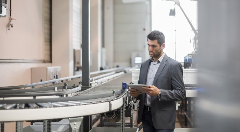 Production manager studying the Master Production Schedule (MPS) in a factory.