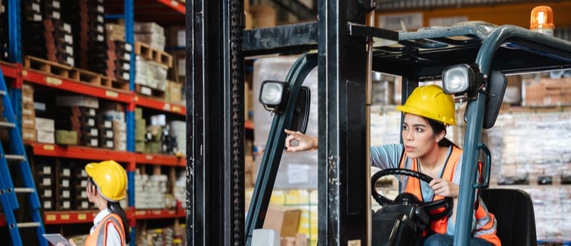 Worker in a warehouse with high inventory turnover.