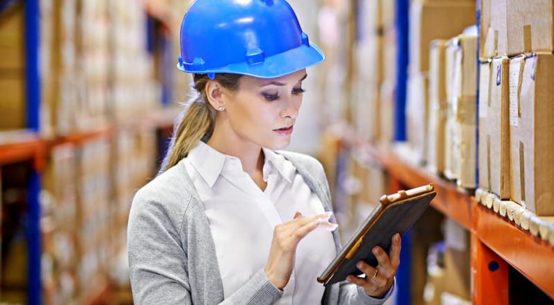 Warehouse worker reviewing supply chain traceability.